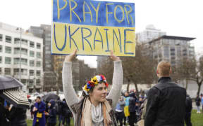 Oksana Zelanik, of Seattle and born in Ukraine, holds a "pray for Ukraine sign" during a "Rally Against the War With Ukraine" event in Seattle, Washington on February 26, 2022.