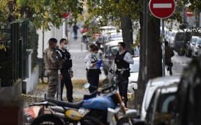 Security and emergency personnel are on October 31, 2020 in Lyon at the scene where an attacker armed with a sawn-off shotgun wounded an Orthodox priest in a shooting before fleeing, said a police source.