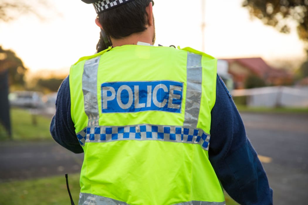 A police officer outside a cordon in South Auckland.
