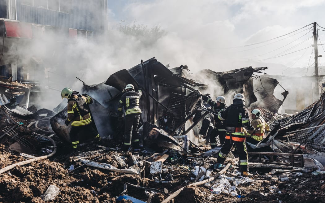 Ukrainian firefighters work at the Bakhmut market after it was shelled by the Russian army, in the city of Bakhmut, Donetsk Oblast of Ukraine on 21 July, 2022.