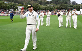 Glenn Phillips holds the ball up as he walks from the field having taken a fiver on Day three of the first cricket test match between New Zealand and Australia at the Basin Reserve.