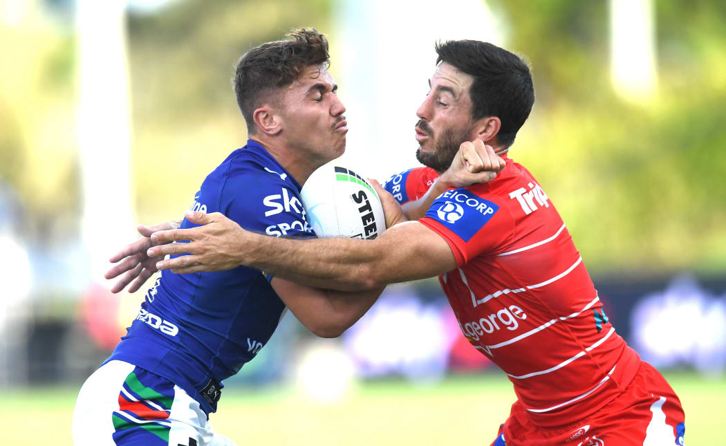 Chanel Harris-Tavita (left) of the Warriors is tackled by Ben Hunt (right) of the Dragons