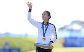 Lydia Ko stands on the podium with her Gold medal after winning the Women's Individual Stroke Play Golf at Le Golf National during the 2024 Paris Olympics.