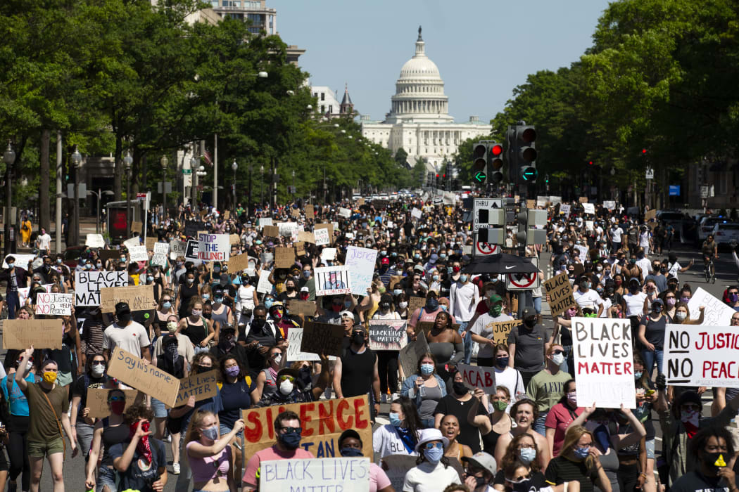 Protesters demonstrate over the death of George Floyd, by a Minneapolis police officer, at a rally on May 30, 2020 in Washington, DC. - Demonstrations are being held across the US after George Floyd died in police custody on May 25. (Photo by Jose Luis Magana / AFP)