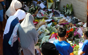 Locals their respects for the Christchurch terror attack victims and place flowers during an Open Day at Preston mosque in Melbourne on March 17, 2019.