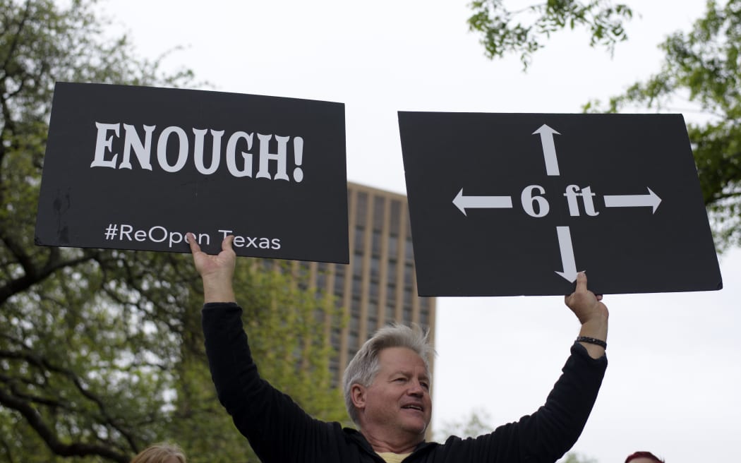 A protester demonstrates during the "Reopen America" rally on April 18, 2020 at the State Capitol in Austin, Texas. (Photo by Mark Felix / AFP)