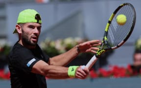 Britain’s Jacob Fearnley returns the ball to Bulgaria’s Grigor Dimitrov during their 2025 ATP Tour Madrid Open tennis tournament third round singles match at the Caja Magica in Madrid, on 28 April, 2025.