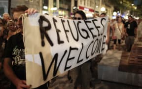 Protesters hold a banner in Vienna during a rally against ill-treatment of migrants.