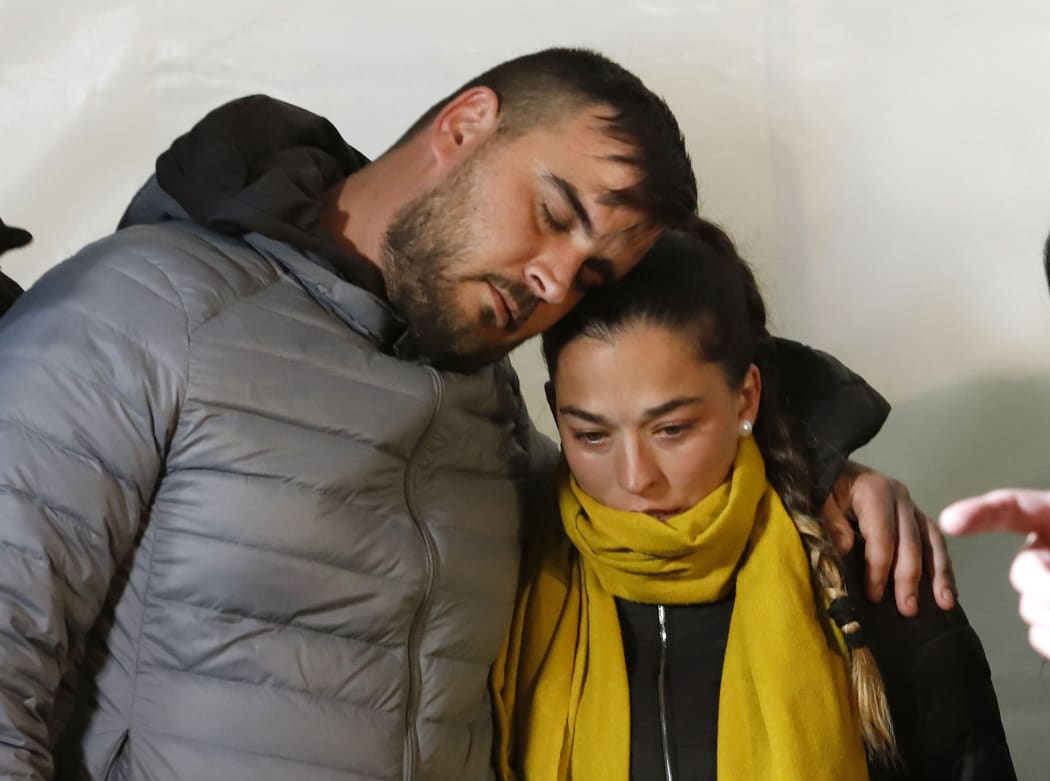 Thursday, Jan. 24, 2019, Jose Rosello and Victoria Garcia, parents of 2-year-old boy trapped in a deep borehole, take part on a vigil at the town of Totalan near Malaga, Spain.