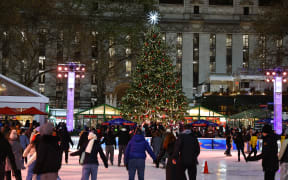 People skate in the Winter Village in Bryant Park in New York, N.Y., on December 12, 2024. The photo is taken as a long exposure. (Photo by Gordon Donovan/NurPhoto) (Photo by Gordon Donovan / NurPhoto / NurPhoto via AFP)