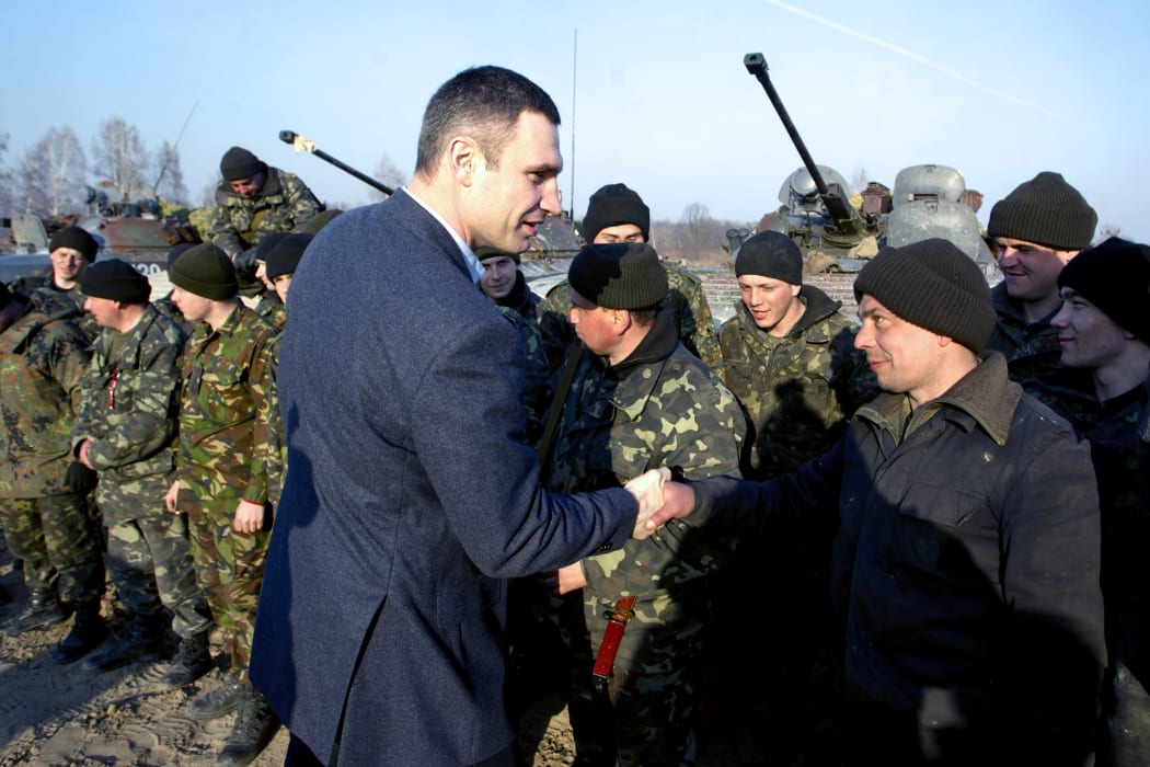 Ukrainian politician  Vitali Klitschko shakes hands with a Ukrainian soldier after  military exercises 150 km from Kiev as the nation braced for  a breakaway vote in Crimea.