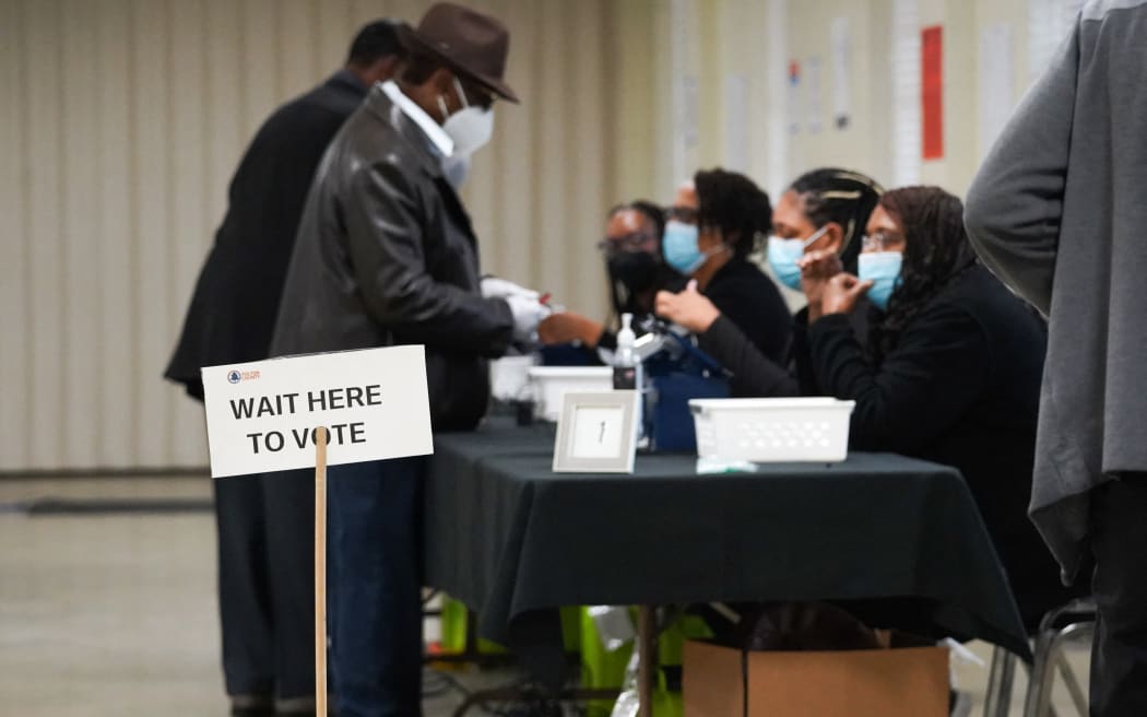 ATLANTA, GEORGIA - OCTOBER 15: People sign in to cast their votes on the first day of early voting at East Point First Mallalieu United Methodist Church on October 15, 2024 in Atlanta, Georgia. Early voting takes place from October 15 - November 1, ahead of Election Day on November 5.   Megan Varner/Getty Images/AFP (Photo by Megan Varner / GETTY IMAGES NORTH AMERICA / Getty Images via AFP)