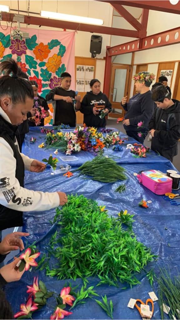 Students learn to create an ei katu or flower garland at Kimi Ora School in Hastings this week.