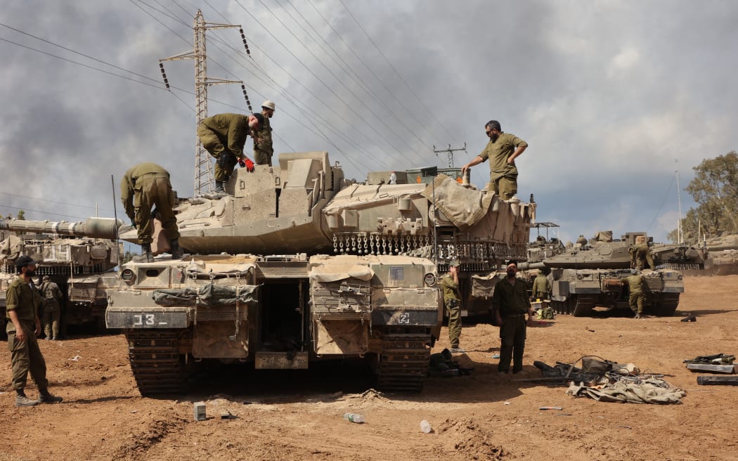 Israeli troops prepare weapons and armed vehicles near the southern city of Ashkelon on 15 October 2023.
