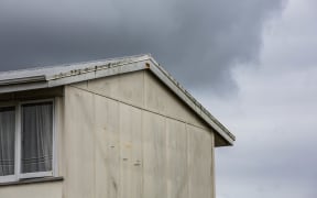A state house with dark clouds above it