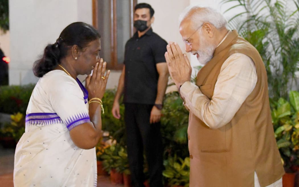 NEW DELHI, INDIA - JULY 21: (----EDITORIAL USE ONLY â€“ MANDATORY CREDIT - "INDIAN PRESS INFORMATION BUREAU/ HANDOUT" - NO MARKETING NO ADVERTISING CAMPAIGNS - DISTRIBUTED AS A SERVICE TO CLIENTS----) Indian Prime Minister Narendra Modi (R) congratulates Smt. Droupadi Murmu (L) on being elected as 15th President of India, in New Delhi on July 21, 2022.. Indian Press Information Bureau / Handout / Anadolu Agency (Photo by Indian Press Information Bureau / ANADOLU AGENCY / Anadolu Agency via AFP)