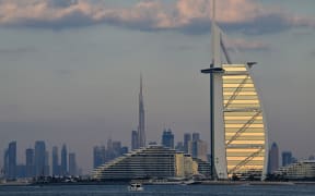 The Burj al-Arab tower and Burj Khalifa, the world’s tallest building, are pictured with the rest of the Dubai skyline on January 4, 2025. (Photo by Giuseppe CACACE / AFP)
