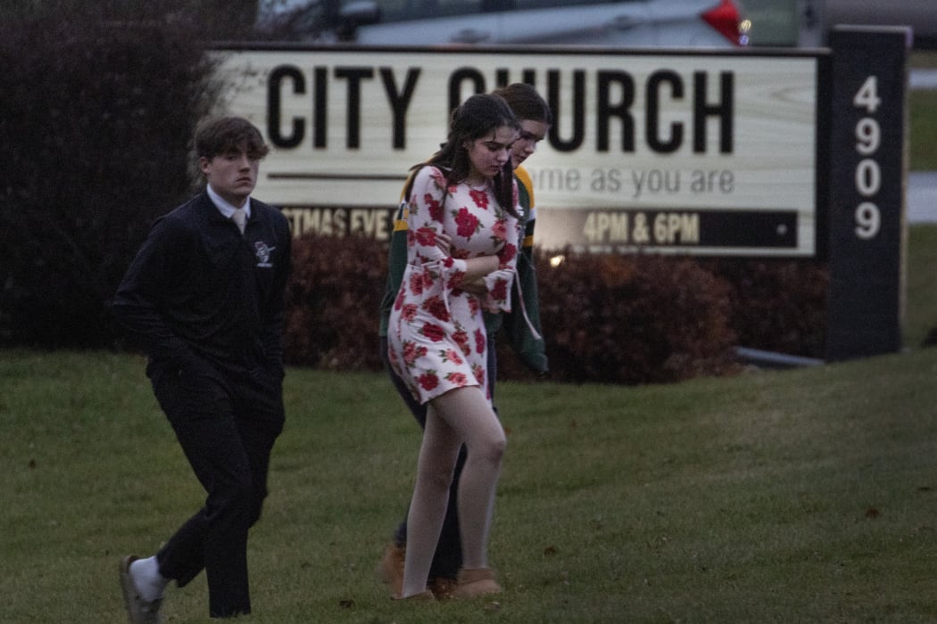 Students are escorted from a church next to the Abundant Life Christian School on 16 December 2024 in Madison, Wisconsin.