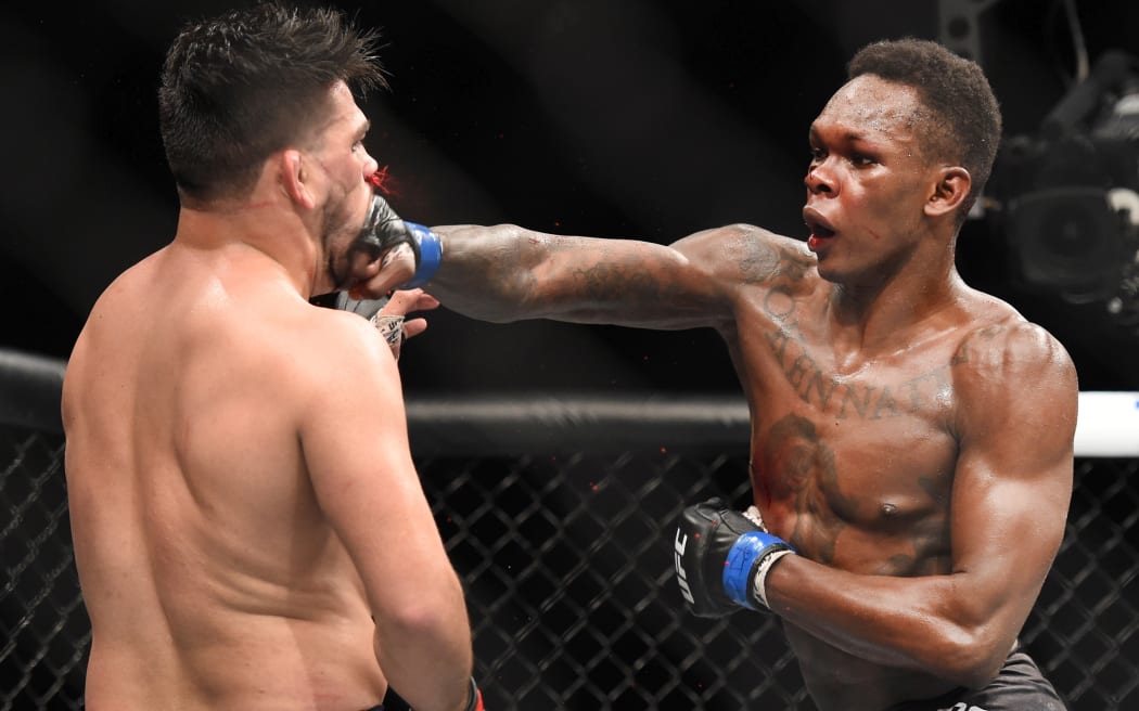 Israel Adesanya (right) fights Kelvin Gastelum