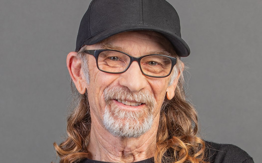 Trevor Reekie smiling wearing a black cap