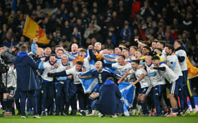 Scotland players celebrate on the pitch after the FIFA World Cup 2026 European qualification football match between Scotland and Denmark at Hampden Park in Glasgow, 2025.