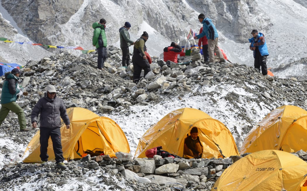 In this photograph taken on April 25, 2018, Nepali Sherpas prepare for a ritual to pay respects to Mount Everest before beginning their climb at Everest base camp, some 140 km northeast of Kathmandu.