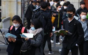 Students wearing a mask attend the second round of  the National Center Test for University Admissions at Universtiy of Tokyo in Bunkyo Ward, Tokyo on Feb. 25, 2020, amid growing fears of the coronavirus spread.
