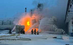 This handout photograph published on the official Telegram account of the governor of the Leningrad region Aleksandr Drozdenko on January 21, 2024, shows rescuers working to extinguish a fire at a natural gas terminal in the Russian Baltic Sea port of Ust-Luga. The terminal, 110 kilometres (70 miles) west of Saint Petersburg near the Estonian border, is operated by Novatek, Russia's largest independent natural gas producer. (Photo by Handout / Telegram / @drozdenko_au_lo / AFP) / RESTRICTED TO EDITORIAL USE - MANDATORY CREDIT "AFP PHOTO / Telegram account @drozdenko_au_lo" - NO MARKETING NO ADVERTISING CAMPAIGNS - DISTRIBUTED AS A SERVICE TO CLIENTS