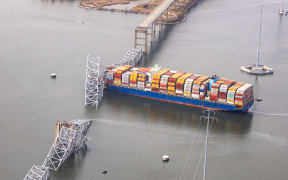 BALTIMORE, MARYLAND - MARCH 26: In an aerial view, cargo ship Dali is seen after running into and collapsing the Francis Scott Key Bridge on March 26, 2024 in Baltimore, Maryland. Rescuers are searching for at least seven people, authorities say, while two others have been pulled from the Patapsco River.   Tasos Katopodis/Getty Images/AFP (Photo by TASOS KATOPODIS / GETTY IMAGES NORTH AMERICA / Getty Images via AFP)