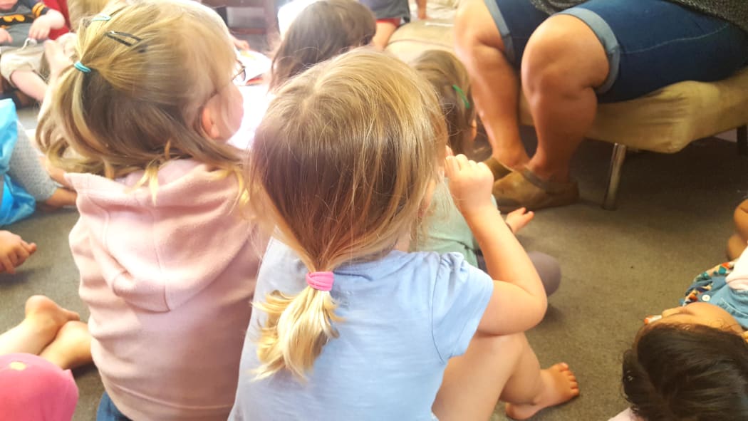 children sit on the mat at an early childhood centre