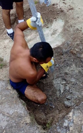 A Manus Island refugee digging another well in the detention centre.