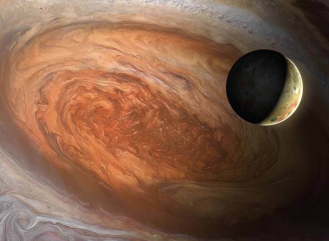 An illustrated Jovian moon Io, seen against the backdrop of Jupiter's Great Red Spot.