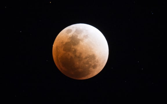 The moon is seen during a lunar eclipse, referred to as the "super blue blood moon", in Kumal, some 105 kms away from Mandalay City on January 31, 2018. Skywatchers were hoping for a rare lunar eclipse that combines three unusual events -- a blue moon, a super moon and a total eclipse -- which was to make for a large crimson moon viewable in many corners of the globe. (Photo by YE AUNG THU / AFP)