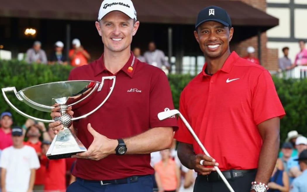 Justin Rose with the FedEx Championship trophy and Tiger Woods with the Calamity Jane trophy for winning the season ending Tour Championship tournament in Atlanta.