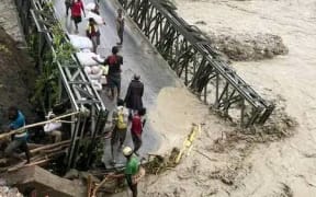 Uria River Bridge, Ramu Valley, Usino Bundi District, Madang Province swept away by angry tide