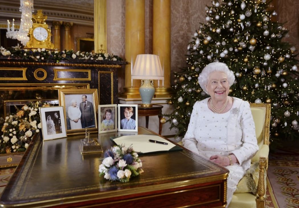 Queen Elizabeth II poses at a desk in the 1844 Room at Buckingham Palace after recording her Christmas Day broadcast to the Commonwealth.