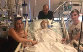 New Zealand mother Abby Hartley in a Bali Hospital with her children, Sophie and Toby, and husband, Richard.