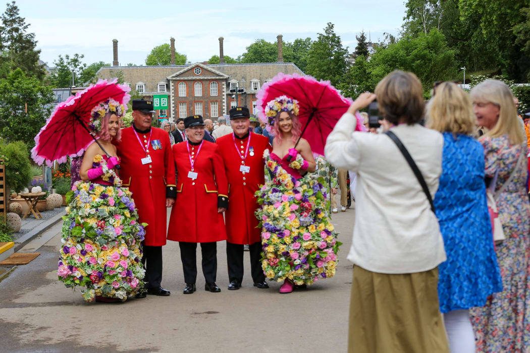 LONDON, UNITED KINGDOM - MAY 23: Women take photos of models wearing floral outfits on the press preview day of the RHS Chelsea Flower Show held by the Royal Horticultural Society at Royal Hospital Chelsea in London, United Kingdom on May 23, 2022. This year's show feature special displays to mark the Queen's platinum jubilee. Dinendra Haria / Anadolu Agency (Photo by Dinendra Haria / ANADOLU AGENCY / Anadolu Agency via AFP)