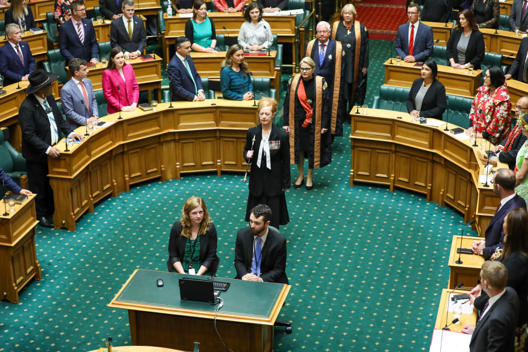 Usher of the Black Rod Sandra McKie leads the three Commissioners, Chief Justice Dame Helen Winkelmann, Sir William Young, and  Dame Susan Glazebrook