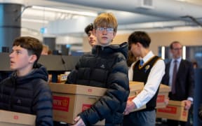 Rongotai College is back to help Wellington Library move books back in