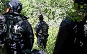 State police guard a mass grave that was found earlier this month near Iguala in Guerrero state.