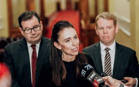 Jacinda Ardern flanked by Grant Robertson, left, and Chris Hipkins, right.
