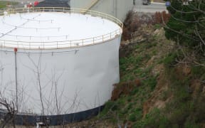 The Lyttelton oil tank that leaked after being hit by a landslide.