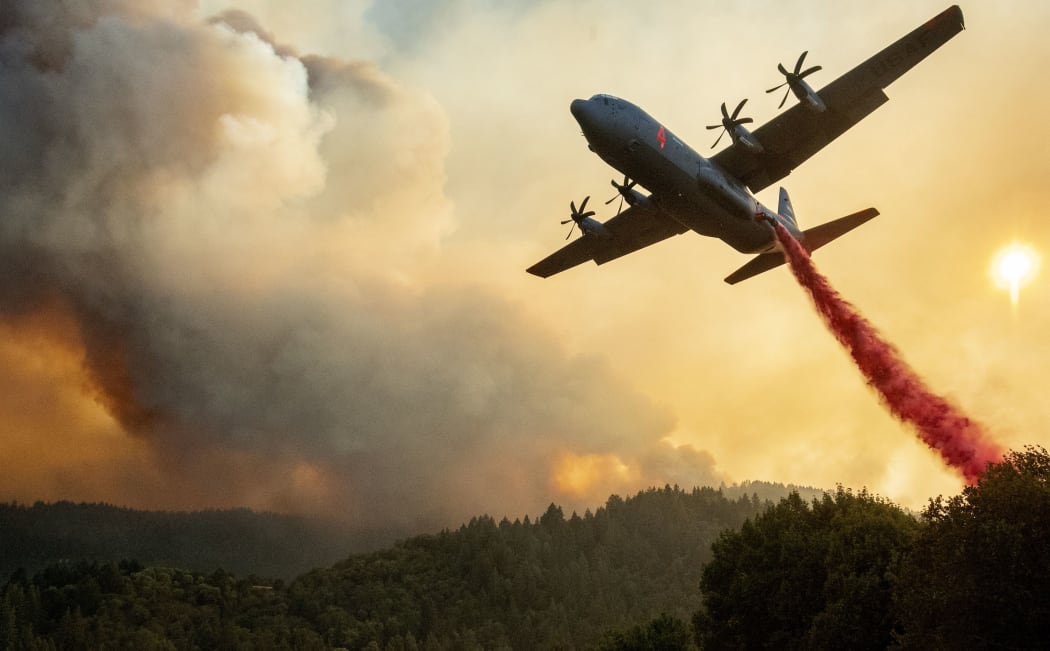An aircraft drops fire retardant on a ridge during the Walbridge fire, part of the larger LNU Lightning Complex fire as flames continue to spread in Healdsburg, California on August 20, 2020.