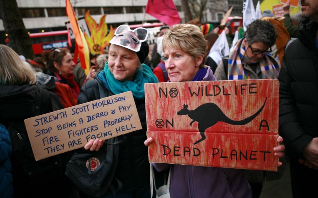 Members of climate change activist movement Extinction Rebellion (XR) protest the Australian government's response to its ongoing bushfires emergency at a demonstration outside the Australian High Commission in London, England.