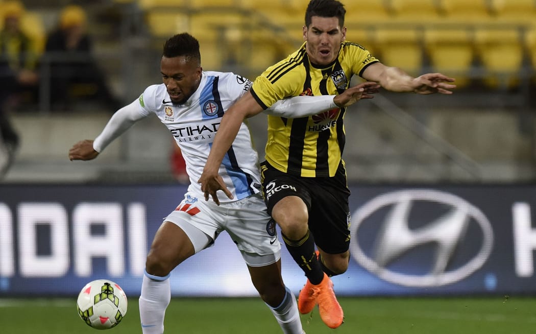 Phoenix defender Michael Boxall (right) contests possession with Melbourne City's Harry Novillo.