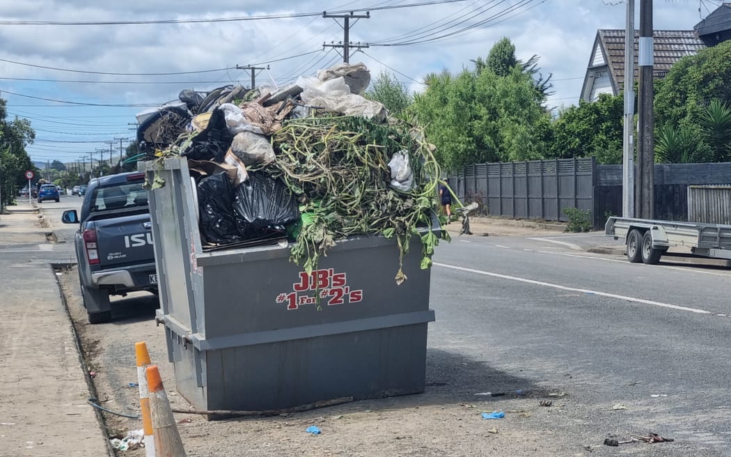 Trucks, trailers and diggers clear silt and move rubbish and debris in Waipawa which was hit badly during Cyclone Gabrielle.
