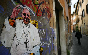 A picture shows a collage by street artist Harry Greb depicting Pope Francis, in a street of Rome on April 28, 2025. (Photo by Gabriel BOUYS / AFP) / RESTRICTED TO EDITORIAL USE - MANDATORY MENTION OF THE ARTIST UPON PUBLICATION - TO ILLUSTRATE THE EVENT AS SPECIFIED IN THE CAPTION