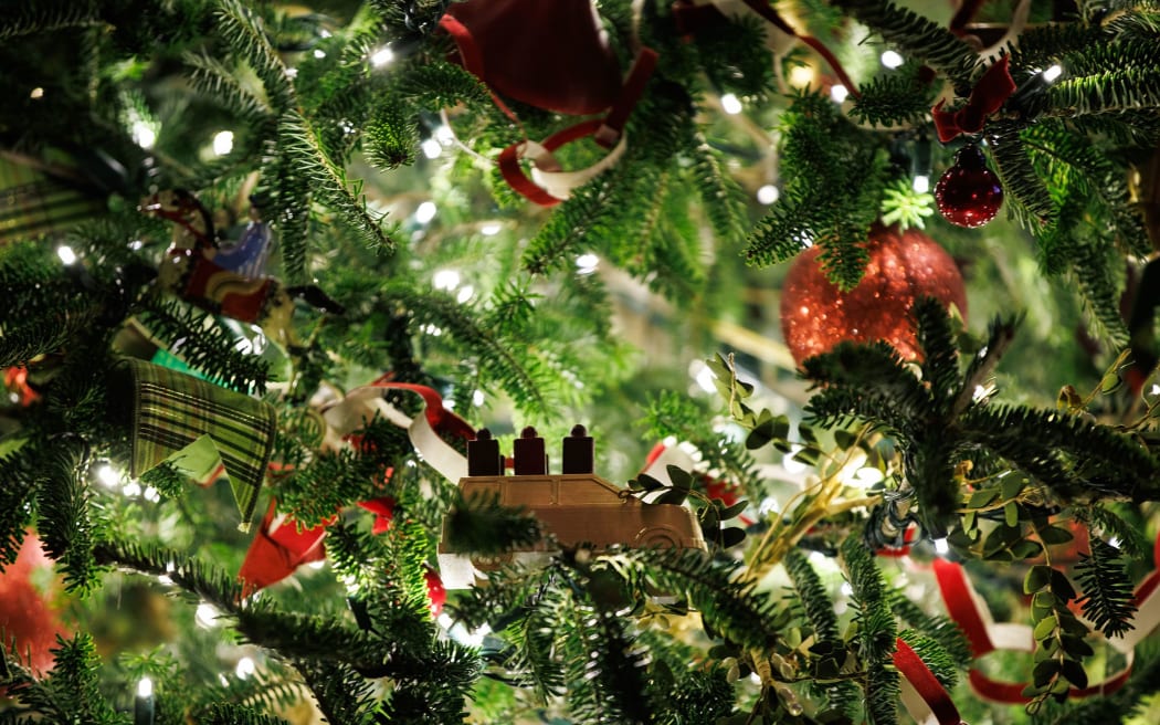 Christmas ornaments adorn a tree in the Green Room.