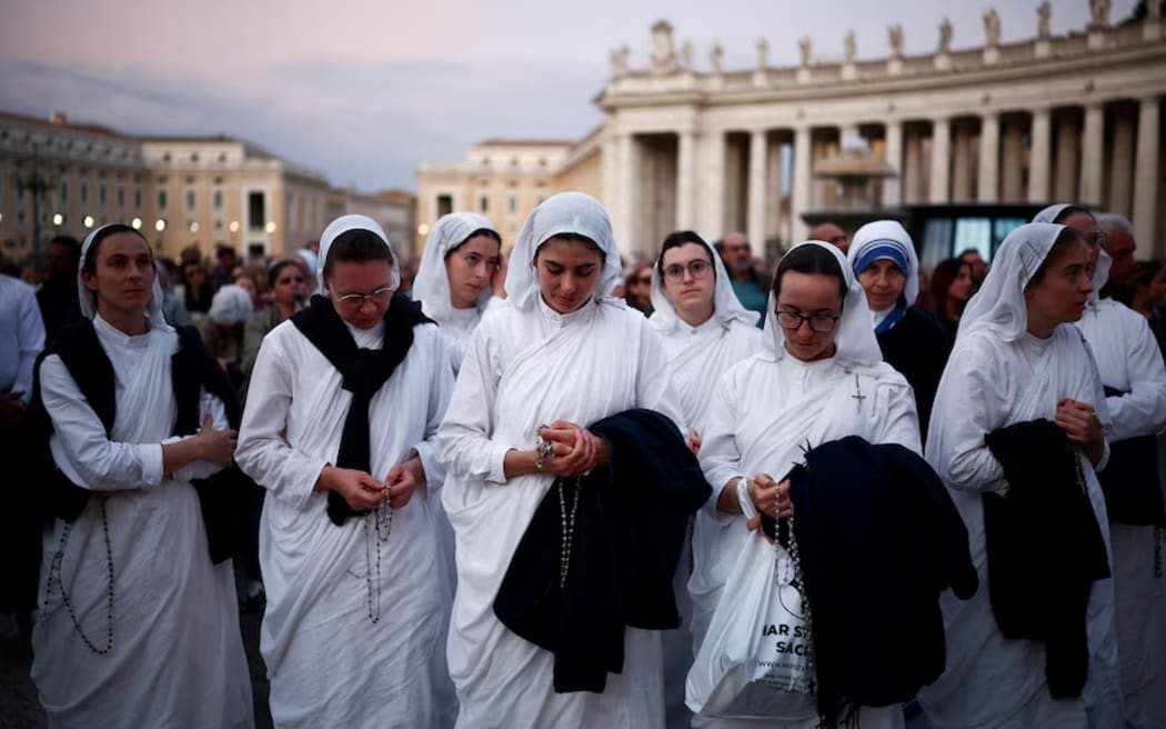Nuns attend a rosary for Pope Francis at the Vatican following his death.